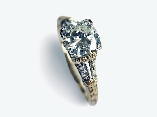  An American Early 20th Century Diamond Solitaire Ring with an Ornate Pierced Scroll Setting